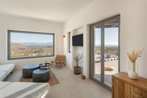a bedroom with a bed and a large window at Sunrise Poem Estate - 16 people capacity in Prodromos Paros