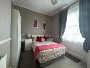 a small bedroom with a bed and a window at Spring Garden Guest House in Gosport +7 photos