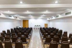 an empty lecture hall with chairs and a podium at Hotel Pan Americano in Sao Paulo