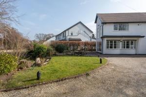 a house with a yard in front of it at Robins Perch, Bramhall in Bramhall