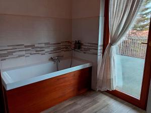 a bath tub in a bathroom with a window at La Gemma Netro in Netro +26 photos