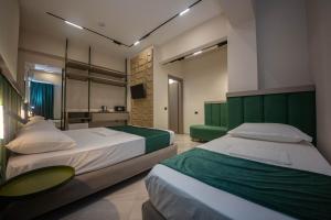 Postel nebo postele na pokoji v ubytování Hotel Royal