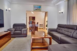 a living room with a couch and a table at SERENITY Flat2 in Pointe-Noire