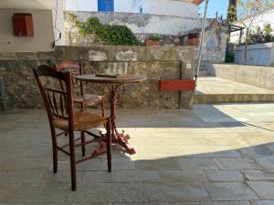 a table and a chair on a patio at MantasHouse in Spetses