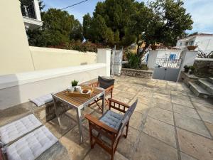 a patio with a table and chairs on a patio at MantasHouse in Spetses