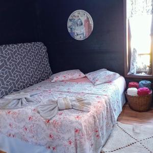 un letto con un piumone bianco e un arco sopra di CASA Vida a São Francisco do Sul