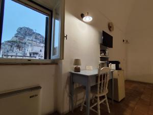 a room with a table and a window and a desk at Agli Archi Dimore Storiche in Matera +51 photos