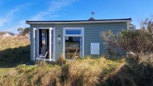 a small house sitting on top of a hill at G17 St Meva, Riviere Towans in Hayle