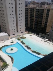 an overhead view of a large swimming pool in a city at 4º Città Residence - Piscina e academia in Brasília