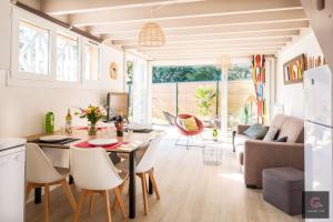 a kitchen and living room with a table and chairs at Maison de vacances à Biscarrosse lac pour 6 personnes in Biscarrosse