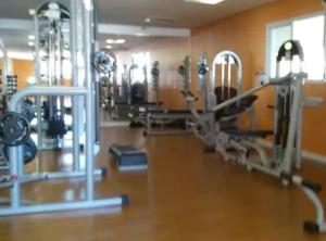 a gym with several treadmills and machines at 4º Città Residence - Piscina e academia in Brasília