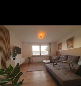 a living room with a couch and a window at Ferienwohnung in einer idyllischen Lage in Bremerhaven