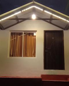 a house with a window and a door at Mountain view cottage in Rishīkesh