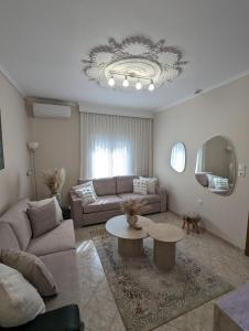 a living room with a couch and a table at Under Castle Walls cottage in Thessaloniki