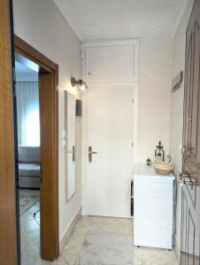 a white bathroom with a sink and a mirror at Under Castle Walls cottage in Thessaloniki +24 photos