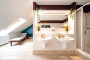 a bathroom with two sinks and a staircase at 5BD Duplex - Billiard - Home Cinema - Central in Prague +27 photos