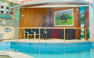 a house with a swimming pool in the middle of a house at Hotel Daylu in Iquitos