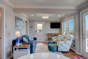 un salon avec un canapé, des chaises et une télévision dans l'établissement Sea Biscuit, à Surf City 19 autres photos