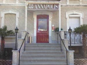 a building with a red door and stairs in front at Annapolis in Aix-les-Bains