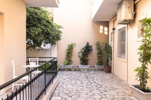 a courtyard of a house with potted plants at BOHOTEL Eleonas Anex Apartments in Kavos