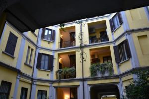 a large building with windows and plants on it at Bubi House Porta Romana in Milan