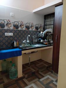 a kitchen with a sink and a counter at Home stay in Tiruvannāmalai