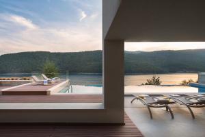a balcony with a view of a lake from a house at Villa Vlastelini 2 in Labin +95 photos