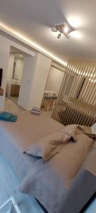 a bedroom with a large bed and a table at departamento boutique centrico- villa carlos paz in Villa Carlos Paz +7 photos