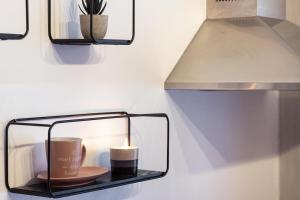 a glass shelf with a candle on a wall at COMO The Walls House a pochi passi dal Centro Wi-Fi AC in Como +32 photos