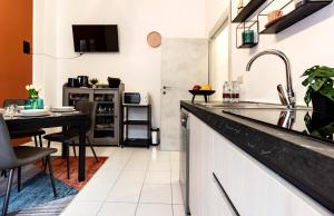 a kitchen with a counter and a dining table at COMO The Walls House a pochi passi dal Centro Wi-Fi AC in Como