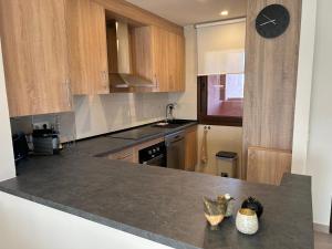 a kitchen with wooden cabinets and a counter top at Casa Matthis in Los Alcázares +15 photos