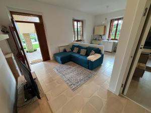 a living room with a blue couch and a kitchen at Casamia Appartament in Marzocca di Senigallia