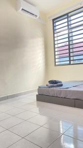 Postel nebo postele na pokoji v ubytování Assyifa Homestay Kulim