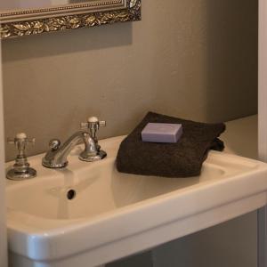 a bathroom sink with a bar of soap on it at B&B Logeren bij van Heeren in Made
