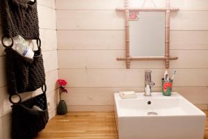 a bathroom with a white sink and a mirror at Les Groseilliers in Moyrazès +15 photos