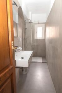 a white bathroom with a sink and a shower at Pisa Paradiso Nice View in Pisa +30 photos