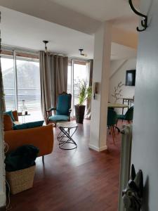 a living room with a couch and chairs and a table at Appart Terrasse in Strasbourg