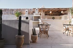 a patio with chairs and a table and cactus at Riad Soulmate in Marrakesh