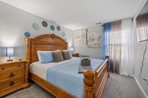 a bedroom with a large wooden bed with blue pillows at Elegant Retreat! Spacious with Outdoor Fireplace! in Richmond