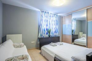 a bedroom with two beds and a mirror at Melitas Sea View Villa in Kassandria