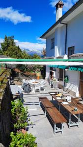a patio with benches and tables on a house at Villa Moiko in La Parra