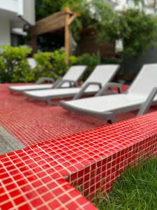 a row of empty lounge chairs on a red table at Wolf Suites in Antalya