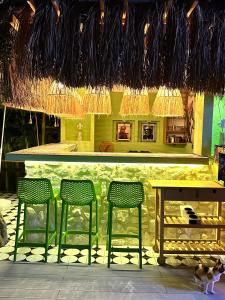 a bar with three stools and a table and chairs at Wolf Suites in Antalya