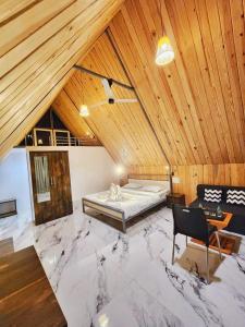 a large room with a bed in a wooden ceiling at Nirved Retreat Resort - A Backwater Forest Peaceful Stay in Bhor, Pune in Āpti