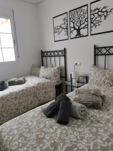 a bedroom with two beds and a window at Gregorys Poolside Villa in Sucina +34 photos