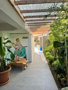 a patio with a painting of a woman on a scooter at Wolf Suites in Antalya