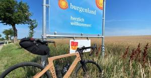a bike parked next to a sign in a field at Sonnenblume Apartment in Oggau