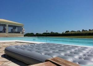 a large swimming pool with a large swimming pool at Casamia Appartament in Marzocca di Senigallia