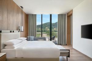 Voodi või voodid majutusasutuse Jim Corbett Marriott Resort & Spa toas +21 fotot