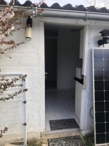 an open door of a building with a gate at Chez Emma in Beauchamp